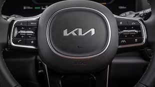 Leather-wrapped, chrome and gloss-black accented wheel with mounted controls for audio, cruise and driver assistance.