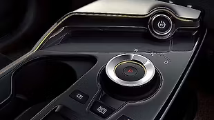 The rotary drive selector with a silver bezel and LED indicator is placed low on the centre console, freeing up room below.