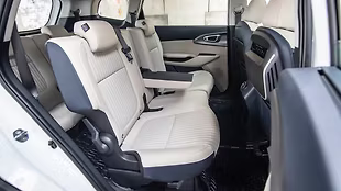 New beige and navy blue upholstery enhances cabin aesthetics.