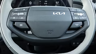 The dual-tone tilt-adjustable steering feels premium, featuring paddle shifters and controls for voice commands and drive/traction modes.